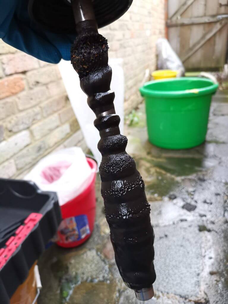Black magnetite sludge pulled from a central heating system